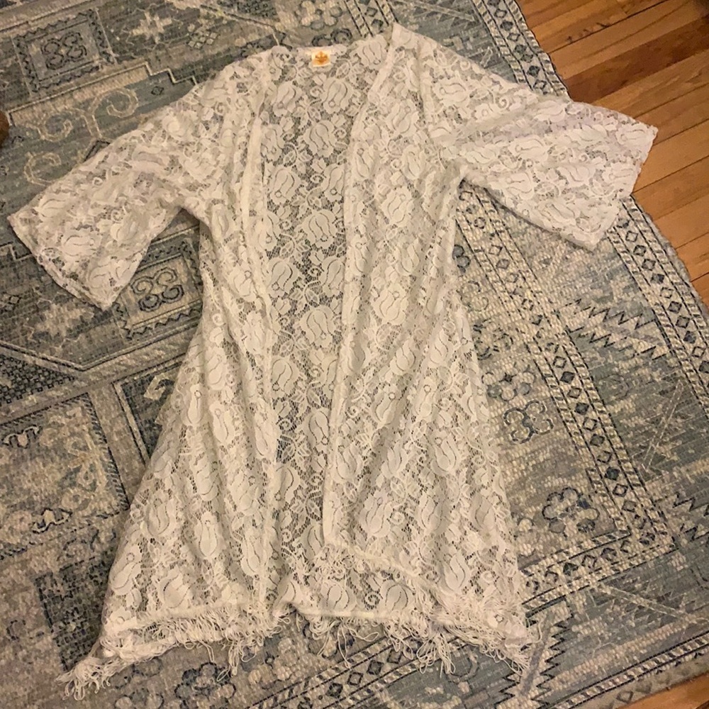 White long lace shawl with fringe detail on the bottom